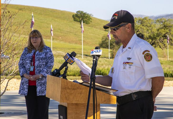 Honor guard member speaking at a ceremony
